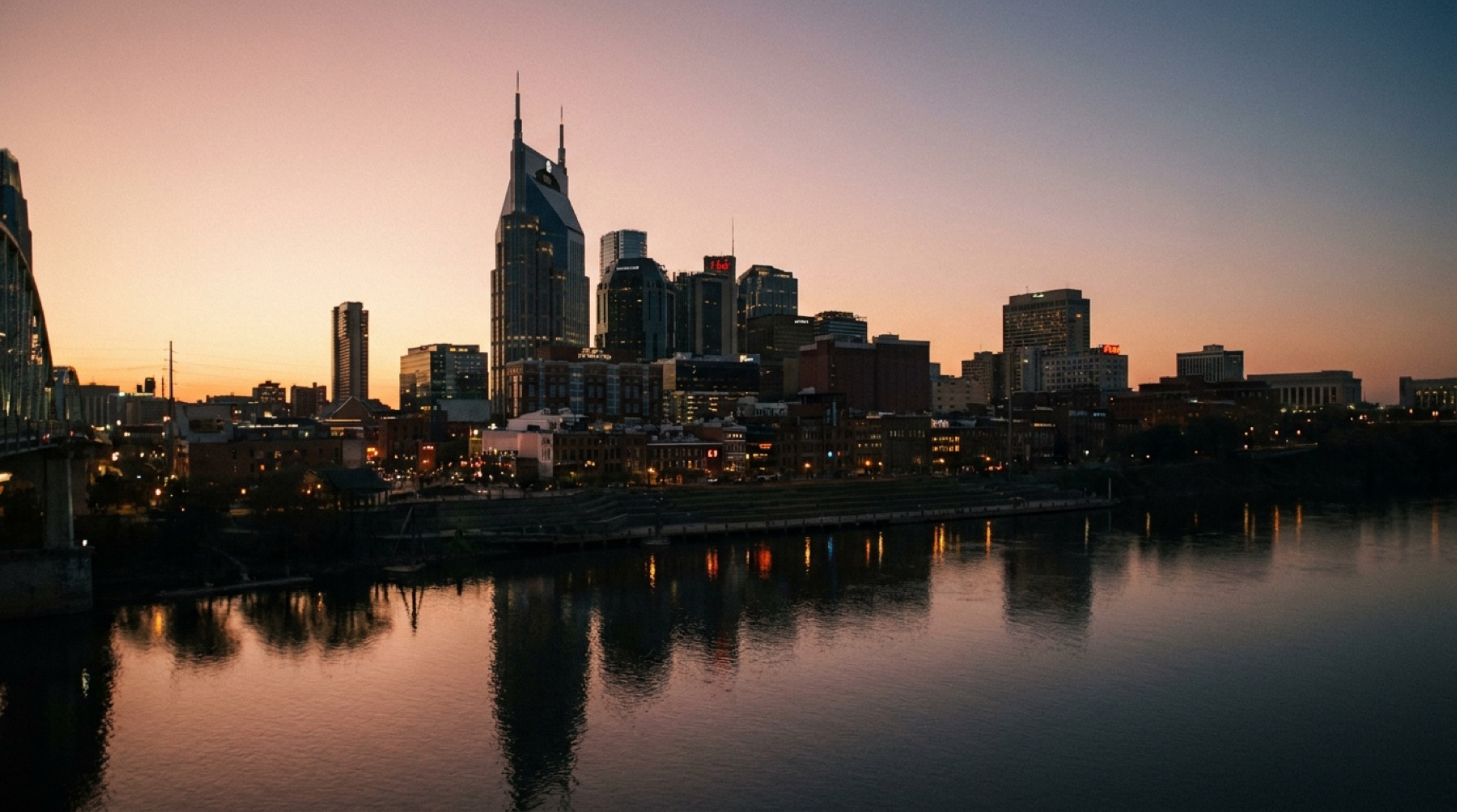 The Nashville skyline at dusk across the Cumberland River